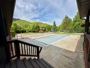 View of sport court featuring a mountain view and fence