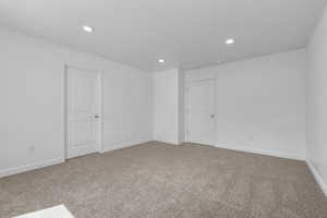 Unfurnished room with baseboards, carpet flooring, and recessed lighting