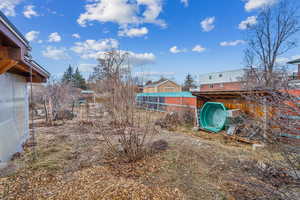 Yard near the north west corner of the house with what's used as a wash station in the summer.