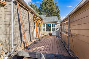 Deck between the house and garage. Supports are for a shade curtain that helps keep the house cool in the summer and keeps utility costs even lower.