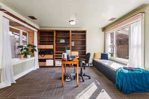 Bright & airy living room with built in window seat overlooking the deck