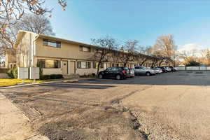 View of front of home with uncovered parking and brick siding