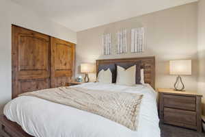 Bedroom featuring dark colored carpet