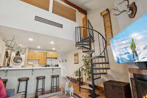 Interior space featuring baseboards, washer / clothes dryer, wood finished floors, and recessed lighting