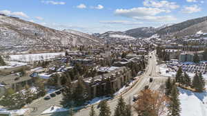 Snowy aerial view featuring a residential view and a mountain view