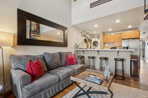 Living room featuring recessed lighting, dark wood finished floors, and stacked washing maching and dryer