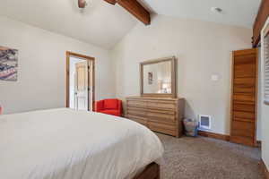 Bedroom with lofted ceiling with beams, carpet floors, ceiling fan, and visible vents