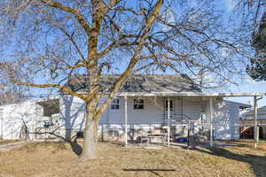 Rear view of house with a yard and a patio