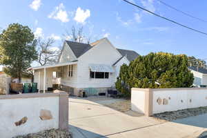 View of front facade featuring roof with shingles and fence