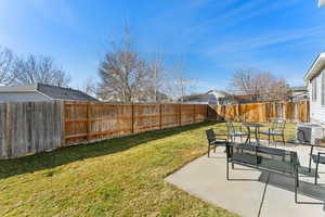 View of yard featuring a patio area, a fenced backyard, and central air condition unit