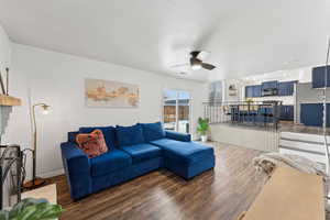 Living area featuring visible vents, dark wood-style flooring, a ceiling fan, and baseboards