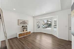 Interior space with dark wood-type flooring, recessed lighting, and baseboards