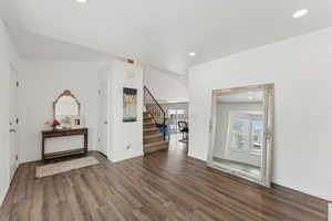 Entryway featuring baseboards, stairway, dark wood finished floors, and recessed lighting