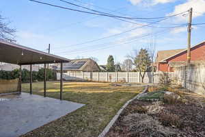 View of yard featuring a patio and a fenced backyard