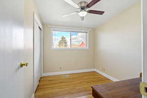 Bedroom featuring ceiling fan, visible vents, baseboards, a closet, and light wood-type flooring