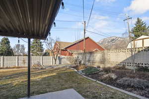 View of yard featuring a fenced backyard and a mountain view