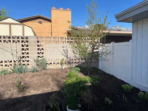 View of property exterior featuring fence