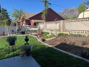 View of yard with a fenced backyard and a mountain view