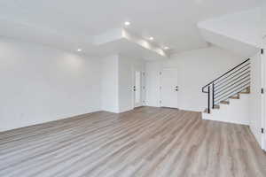 Interior space with stairs, light wood-type flooring, baseboards, and recessed lighting