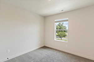 Carpeted empty room with baseboards