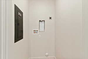 Laundry room featuring hookup for a washing machine, electric dryer hookup, electric panel, and hookup for a gas dryer
