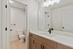 Bathroom with vanity and wood finished floors