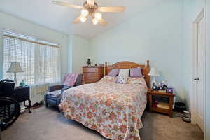 Bedroom with carpet floors, lofted ceiling, and ceiling fan