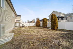 View of yard featuring a fenced backyard and stairs