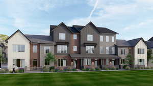 Townhome / multi-family property featuring brick siding, board and batten siding, a front yard, and a shingled roof