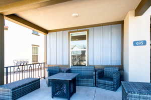 View of patio featuring outdoor lounge area and a balcony