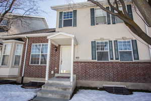 View of front of property featuring brick & stucco