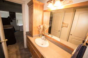 Bathroom with tile patterned flooring and vanity