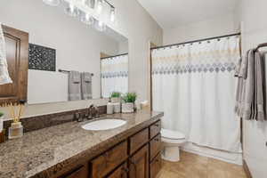 Bathroom featuring tile patterned floors, toilet, and vanity