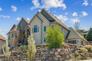 View of side of home with board and batten siding and a garage