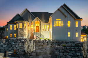 View of front of house featuring board and batten siding and stone siding
