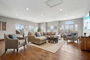 Living room featuring hardwood / wood-style flooring and a healthy amount of sunlight