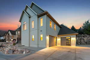 View of front of home featuring a garage, board and batten siding, and driveway