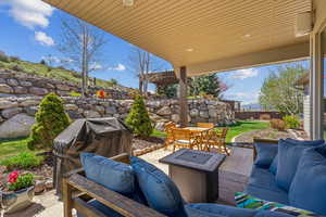View of patio with an outdoor living space, fence, area for grilling, and outdoor dining space
