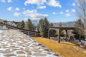 View of yard with a pergola and a mountain view