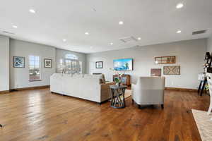 Living room with dark wood-type flooring