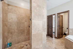 Bathroom with toilet and shower with separate bathtub