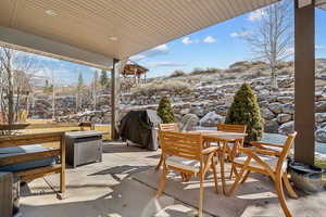 Snow covered patio featuring area for grilling