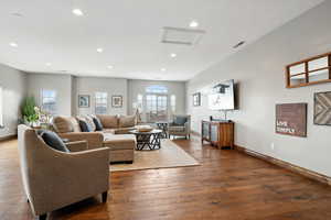 Living room with dark hardwood / wood-style flooring