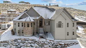 Snow covered back of property featuring a gazebo