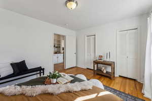 Bedroom with two closets and light wood-style floors