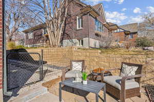 View of patio with a gate and fence