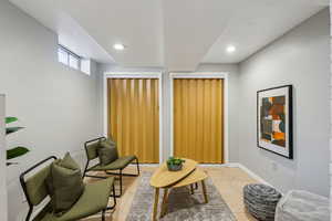 Living area featuring light tile patterned floors, recessed lighting, and baseboards