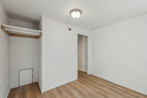 Unfurnished bedroom with light wood-style floors, visible vents, and baseboards