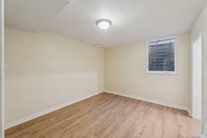 Spare room with light wood-style flooring and baseboards