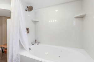 Bathroom featuring a combined bath / shower with jetted tub